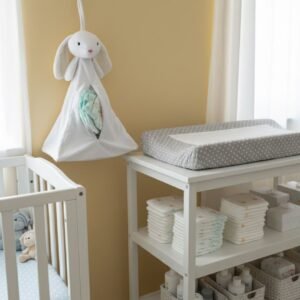 Personalised nursery organiser with nappies stored inside plush hanging pouch
