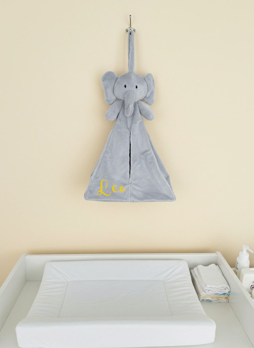 Personalised nursery organiser hanging above changing table in modern Dubai nursery